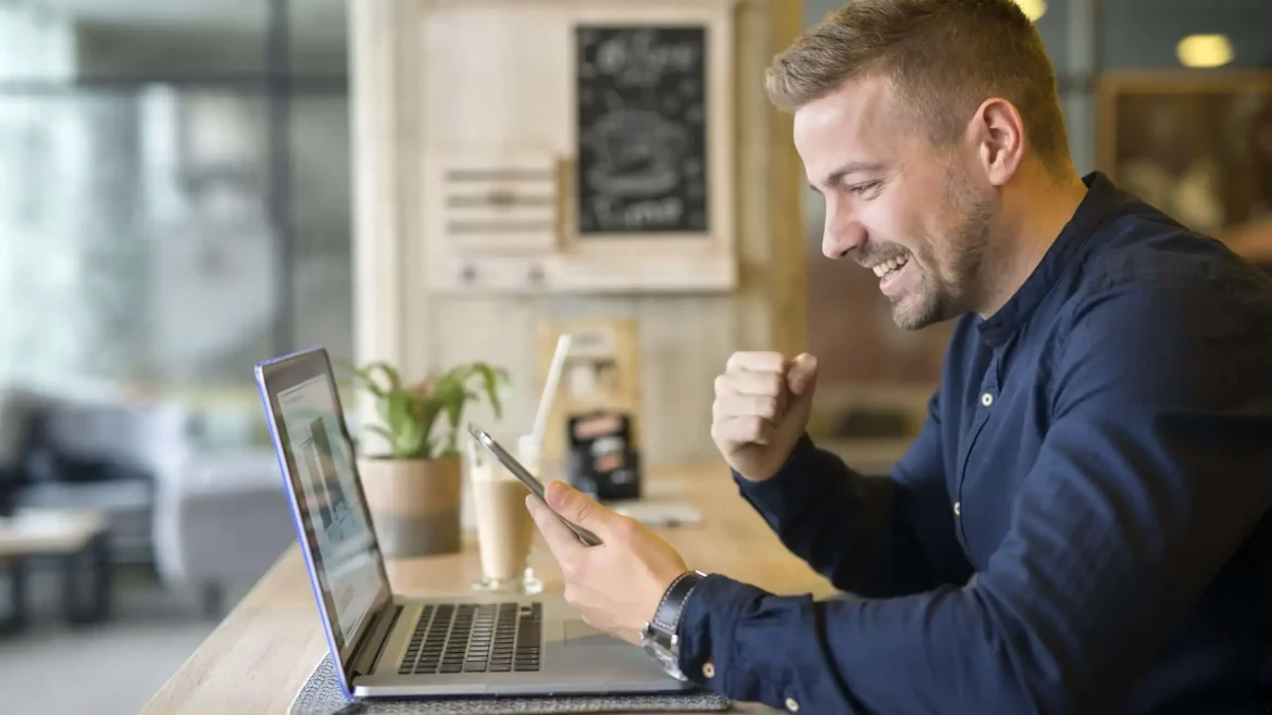 happy freelancer with tablet laptop